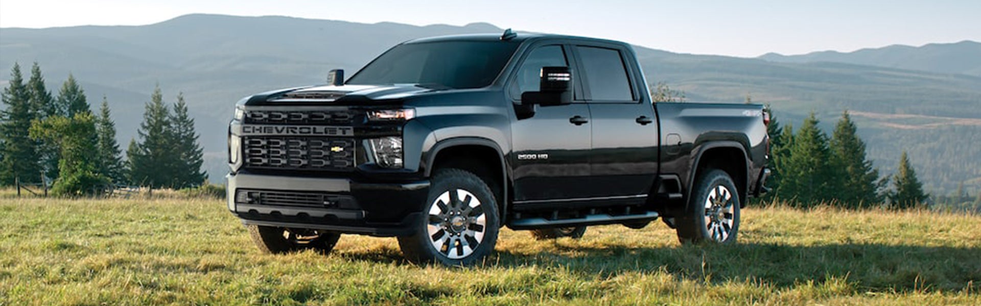 Chevrolet Silverado 2500 HD truck in a mountain setting.