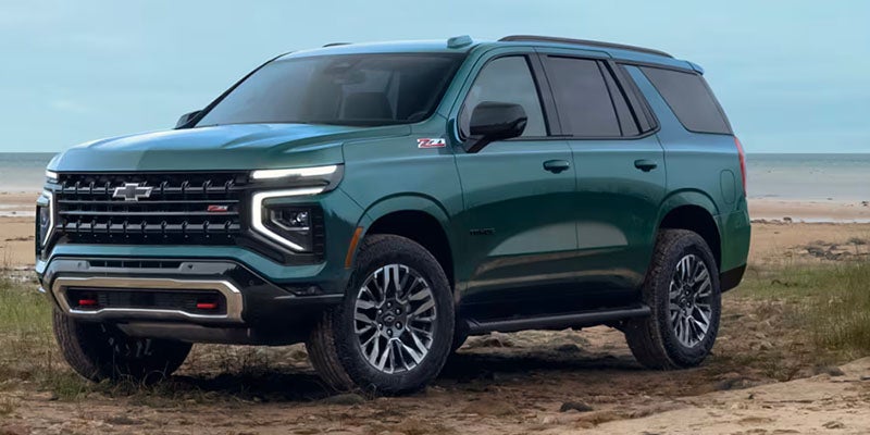 A dark green Chevrolet Tahoe Z71 parked on a sandy beach