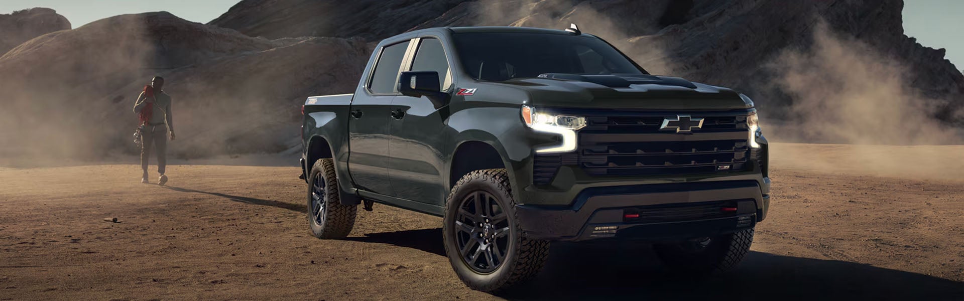 Black Chevrolet Silverado Z71 pickup on an off-road trail. 