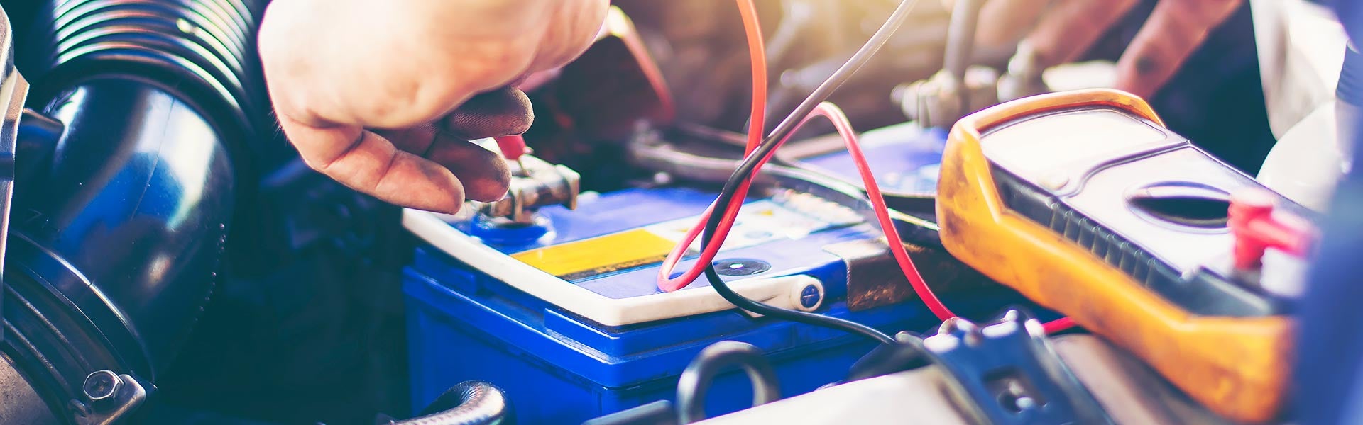 Car battery being tested with diagnostic equipment.